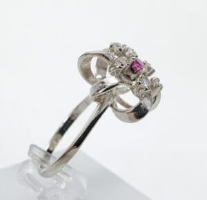 Silver ring with pink gemstone centerpiece.