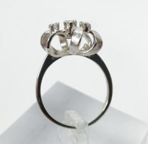 Silver ring with multiple loops and prongs.