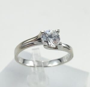 Silver ring with a round diamond solitaire.