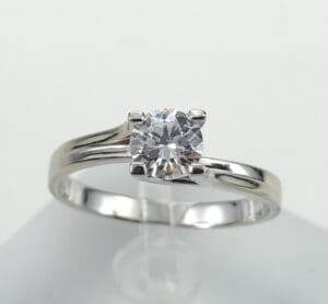 Silver engagement ring with a diamond gemstone.