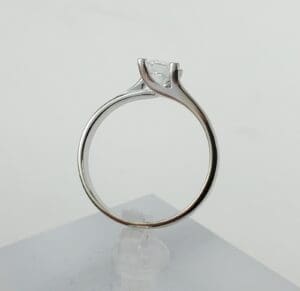 Silver engagement ring with single diamond setting.
