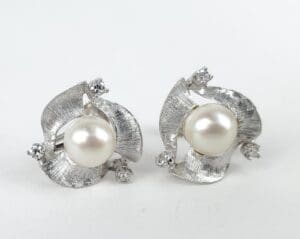 Silver earrings with pearls and small gems.
