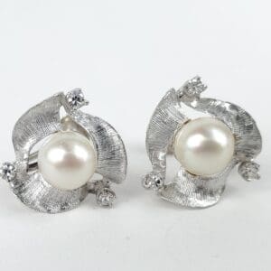 Silver earrings with pearls and small gems.