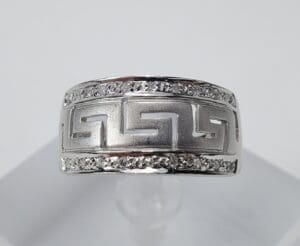 Silver ring with geometric design and stones.