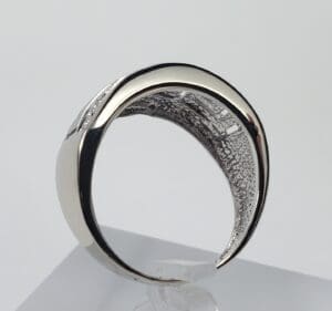 Silver ring with intricate interior design.