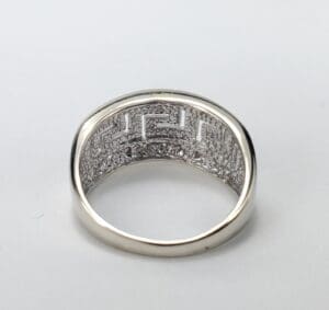 Silver ring with intricate geometric pattern design.