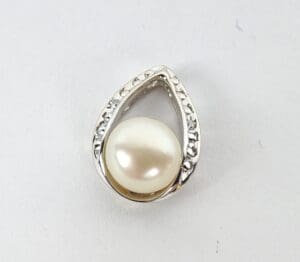Teardrop-shaped pendant with pearl and gems.
