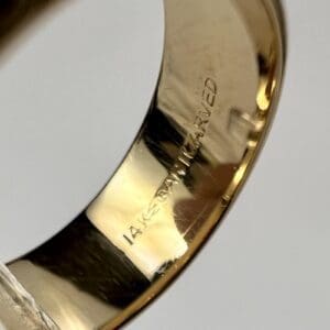 Close-up of 14K gold engraved ring.