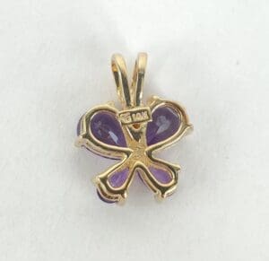 Gold and purple clover-shaped pendant.