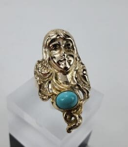 Gold ring with turquoise stone.