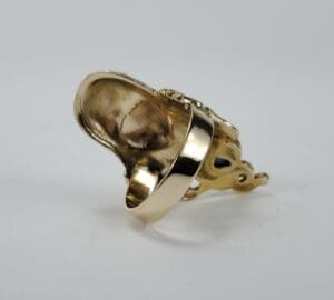 Gold ring with intricate design details.