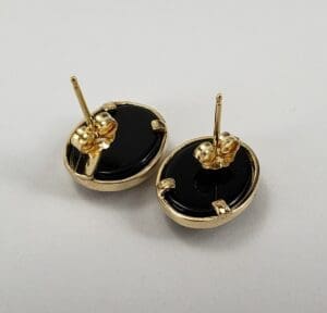 Gold and black oval stud earrings.