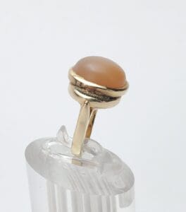 Gold ring with a brown gemstone.