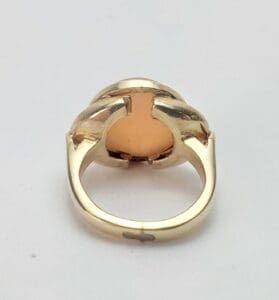 Gold ring with intricate band design.
