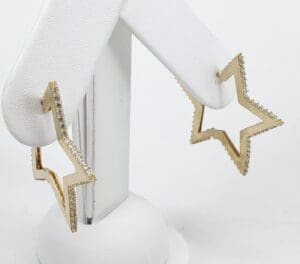 Star-shaped gold earrings with diamond accents.