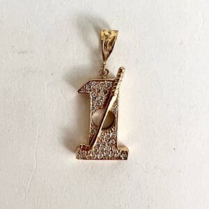 Gold pendant with diamond accents and bat.