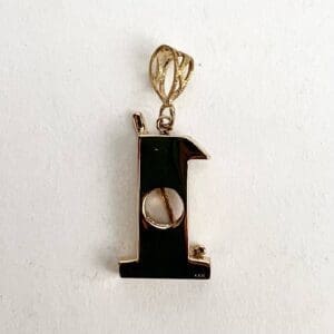 Gold pendant in the shape of "L".