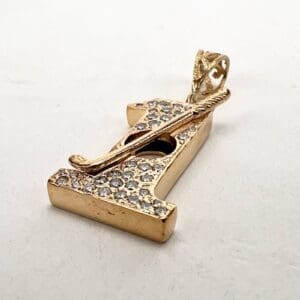 Gold pendant with studded letter "I".