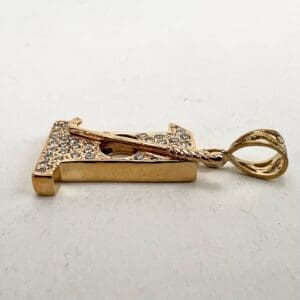 Gold letter pendant with rhinestones on loop.