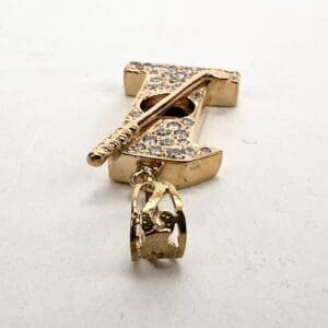 Gold pendant with crystal embellishments.