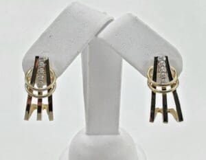 Gold and silver earrings with diamonds displayed.