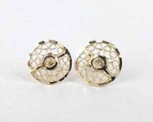 Gold circular earrings with intricate patterns.