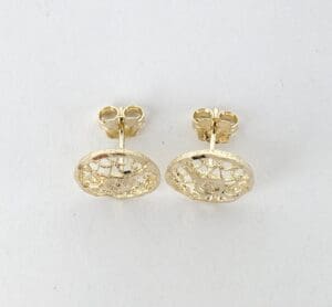 Gold textured stud earrings on display.