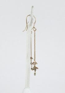 Gold chain earrings with delicate charms.