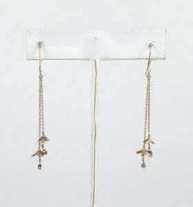 Gold dangling earrings with delicate charms.
