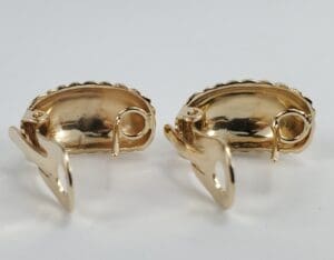 Gold clip-on earrings with curved design.