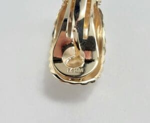 Gold earring back with "14K M" marking.