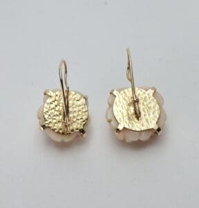 Gold and white round drop earrings.
