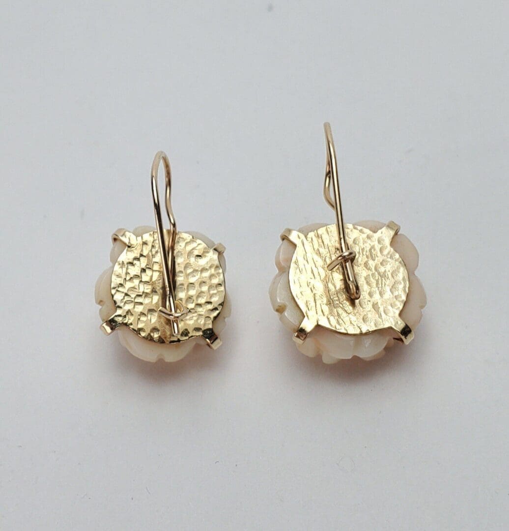 Gold and white round drop earrings.