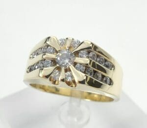 Gold ring with diamond accents displayed upright.