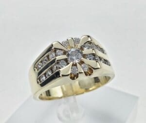 Gold ring with multiple diamonds on display.