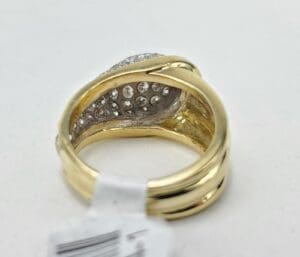 Gold ring with embedded diamonds, white background.