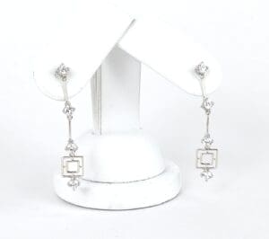 Silver drop earrings with geometric design.