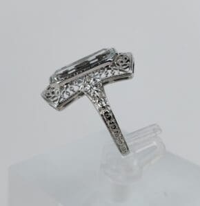 Ornate silver ring with rectangular gemstone.