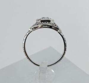 Silver ring with intricate detailing, side view.