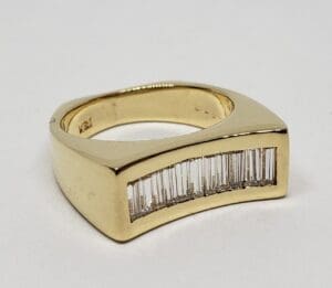 Gold ring with rectangular diamond inlay.