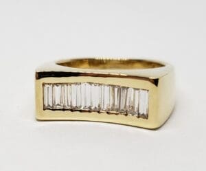 Gold ring with vertical baguette diamonds.