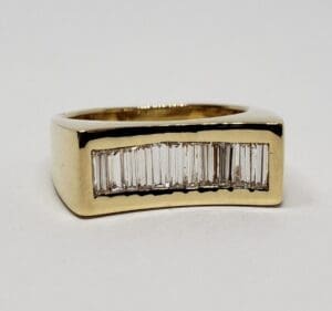 Gold ring with baguette diamond inlay.
