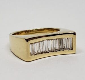 Gold ring with embedded rectangular diamonds.
