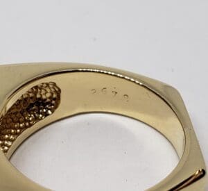 Gold ring with engraved numbers inside.