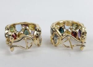 Gold earrings with colorful gemstones displayed.