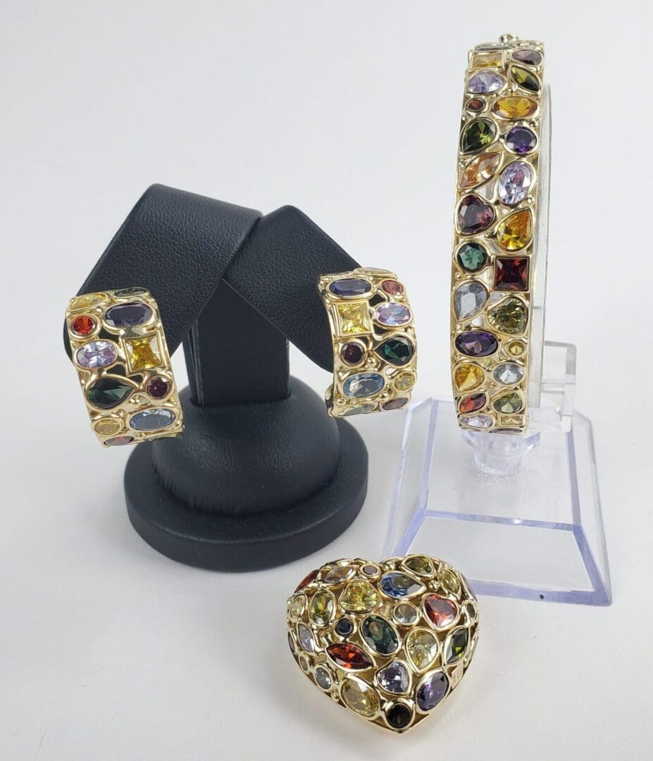 Colorful gemstone jewelry set on display stands.