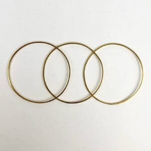 Three overlapping gold circular hoops.