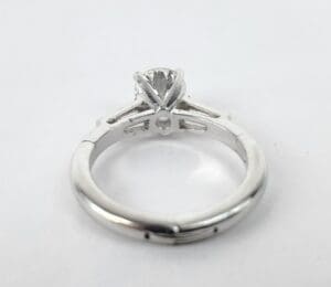 Diamond solitaire engagement ring on white background.