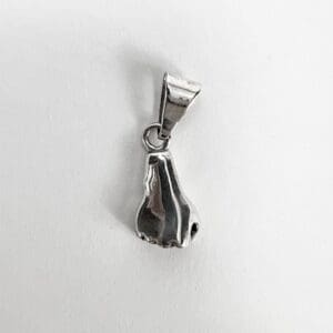 Silver pendant shaped like a nose.