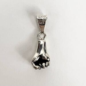 Silver hand-shaped pendant with engraved markings.